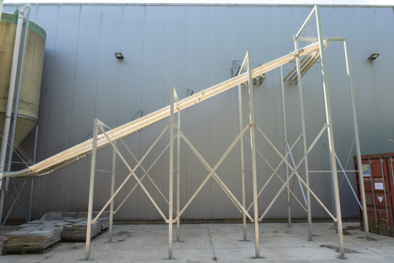 Structure métallique extérieure supportant un système de convoyage industriel surélevé à Engis.